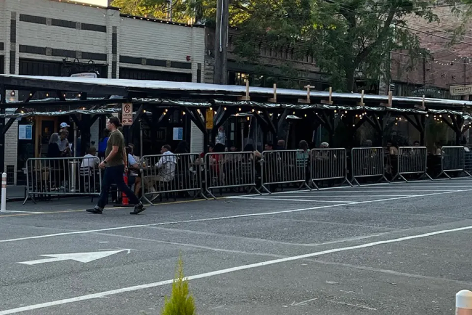 Covered pergolas for outdoor dining line the curb on Ballard Avenue, Seattle